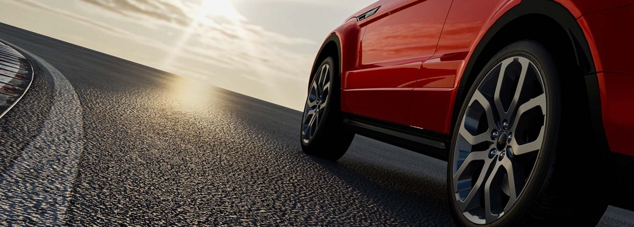 Rode auto rijdt op een weg de zon tegemoet